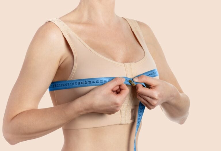 woman taking measurement after breast reduction