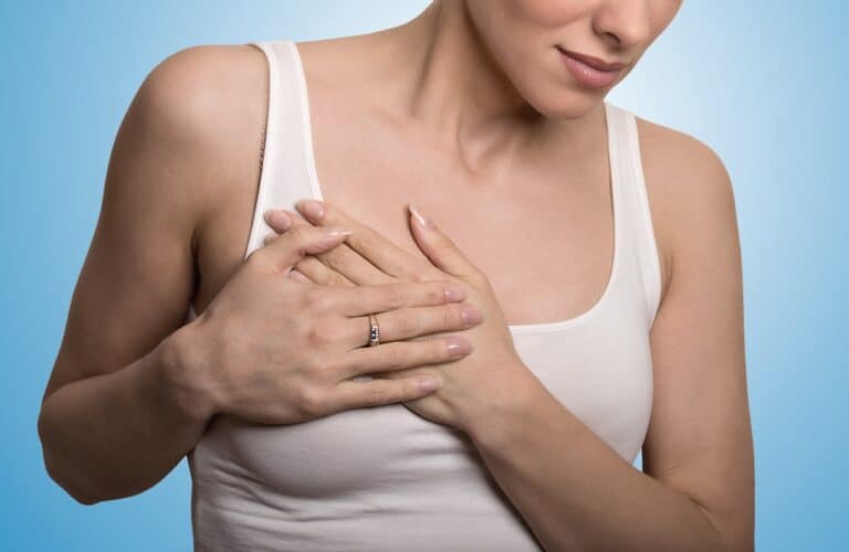 woman's hands on chest